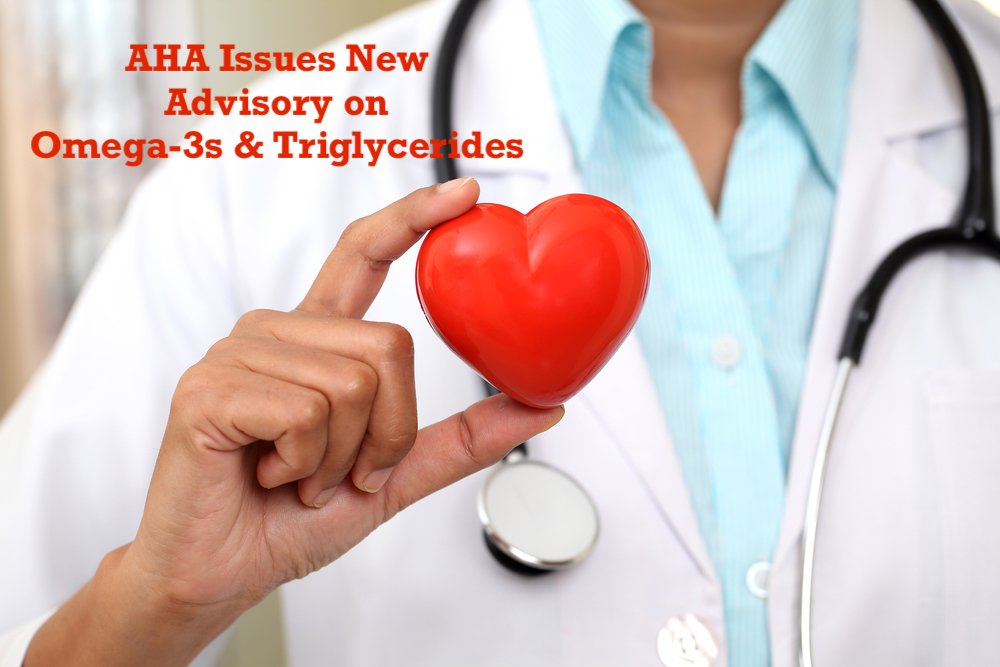 A doctor holding a small red heart, with the text overlay: "AHA Issues New Advisory on Omega-3s & Triglycerides."