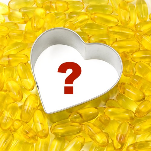Heart-shaped metal mold with a red question mark inside, surrounded by yellow omega-3 fish oil capsules.