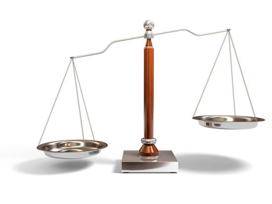 A 3D illustration of an antique brass balance scale with empty pans, showing one side lower than the other.