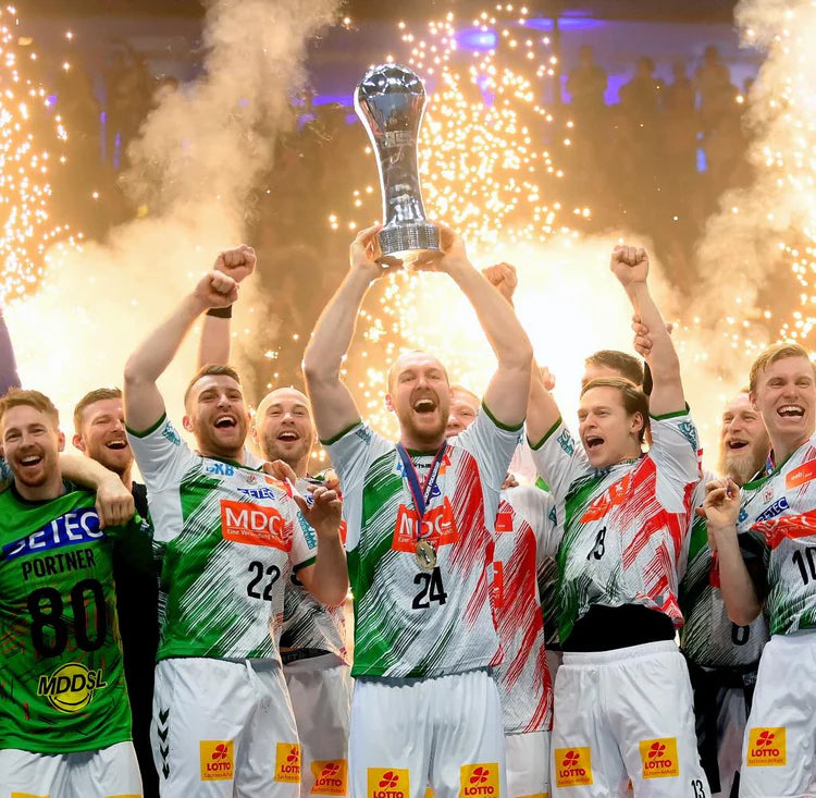 Team of athletes celebrating with a trophy against a fireworks background