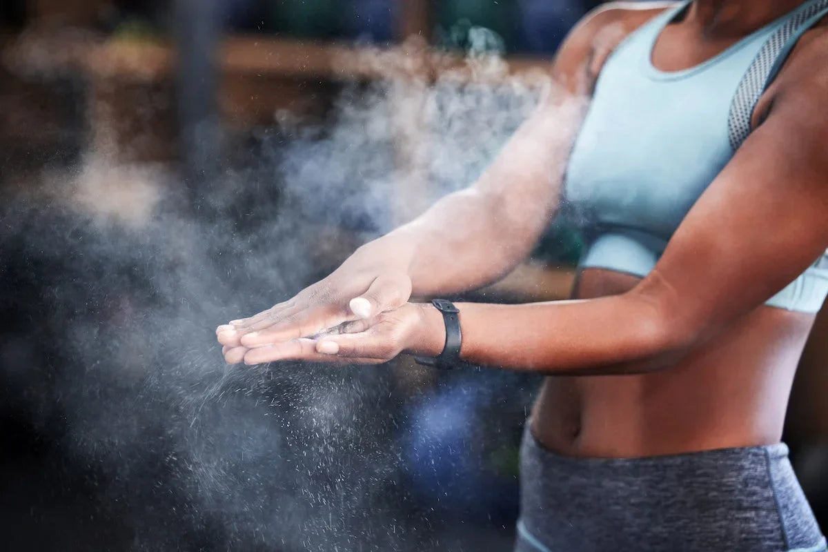 Person applying powder to their hands with a blurred background