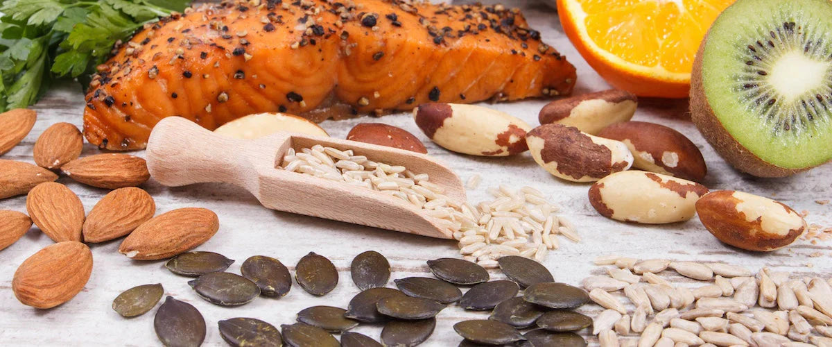 Assorted nuts, seeds, and fruits on a wooden surface