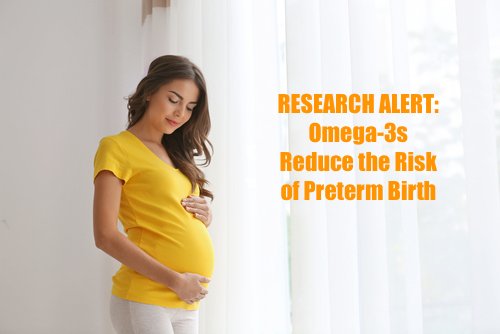 Pregnant woman in a yellow shirt gently holding her belly, with text reading "RESEARCH ALERT: Omega-3s Reduce the Risk of Preterm Birth" displayed beside her.