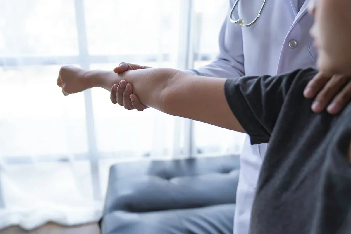 Doctor examining a patient's leg in a medical setting